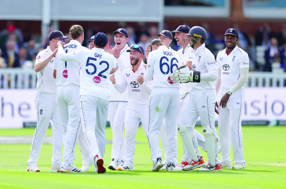 England's Ollie Robinson celebrates with teammates after the LBW wicket of Pakistan's Mohammad Rizwan. — Reuters