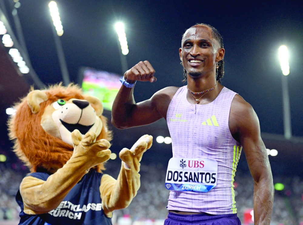 Brazil's Alison dos Santos poses with a mascot after winning the men's 400m hurdles final and setting a new world record REUTERS