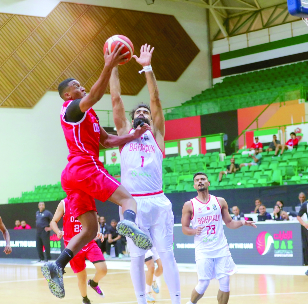 Oman and Bahrain players fight for the ball. — Faiza al Balushi