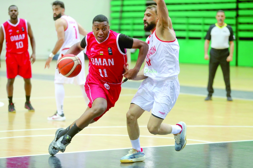 An Oman player tries to move past a Bahrain player. — Faiza al Balushi