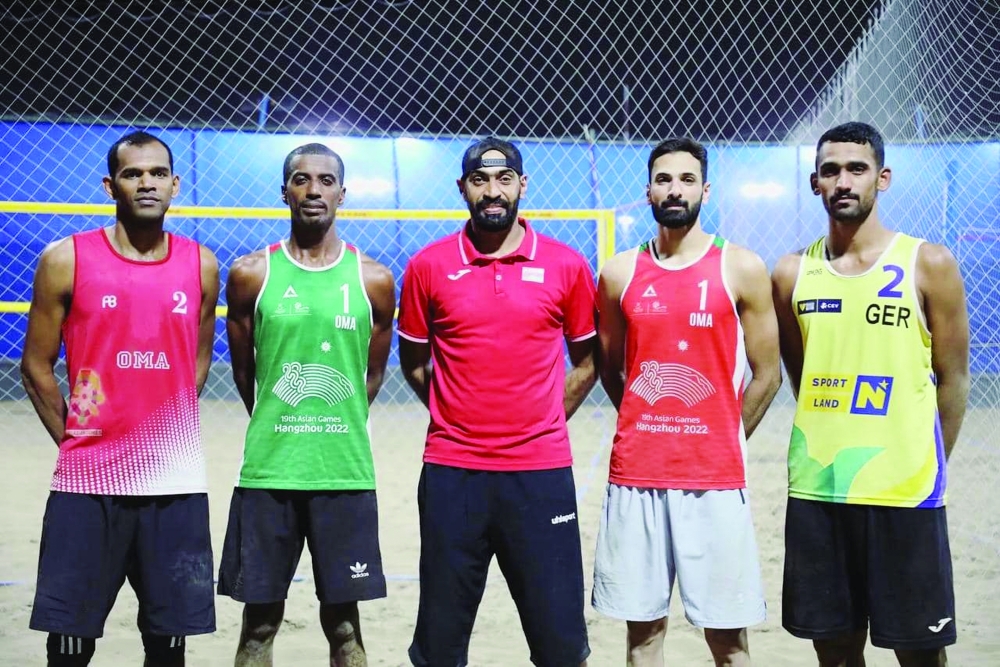 Coach Badar al Subhi with beach volleyball team players.