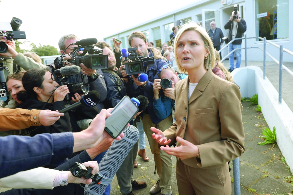 Iceland's Prime Minister Kristrún Frostadóttir talks to the media after voting, at a polling station in Reykjavík. — Reuters