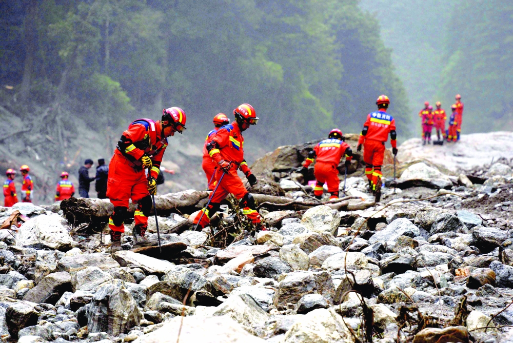Fire and rescue personnel conduct search-and-rescue operations 2 kilometers from Gyirong Port, in Gyirong County, in China’s western Tibet region. — AFP