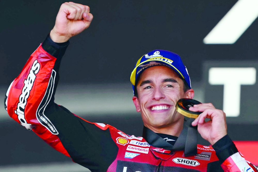 Team Ducati Lenovo Team's Marc Marquez celebrates winning the sprint race of the MotoGP Aragon Grand Prix at the Motorland circuit in Alcaniz, northeastern Spain. — AFP