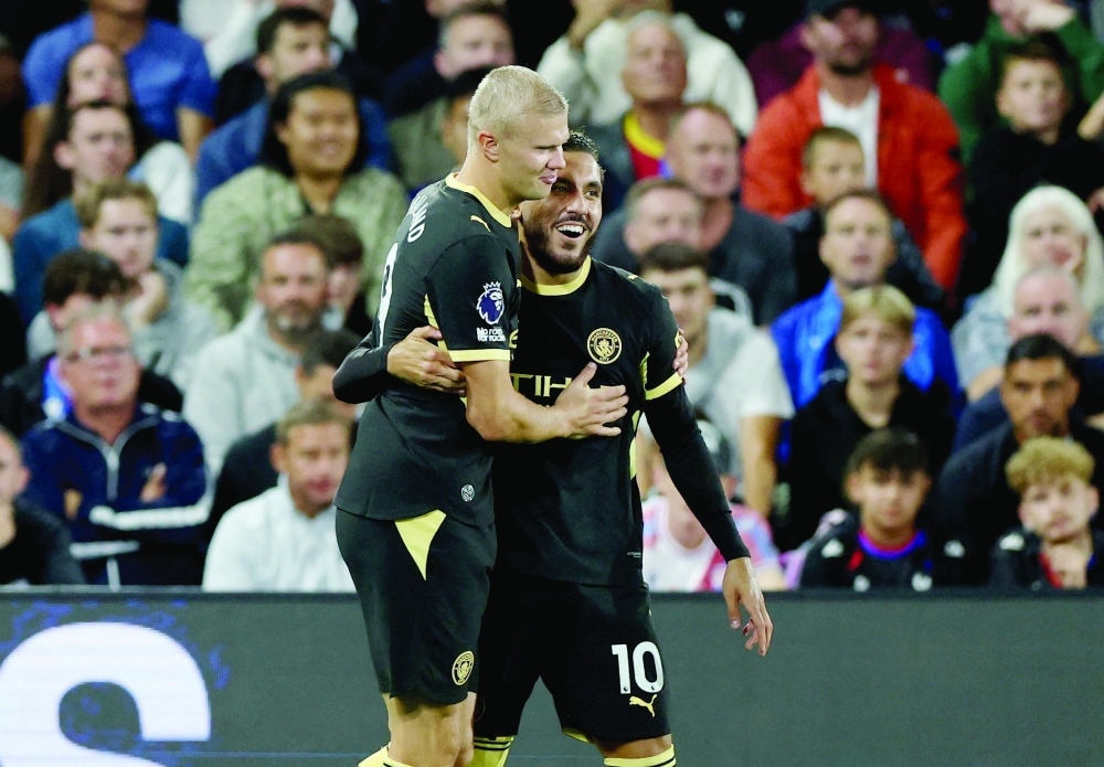 Manchester City's Rayan Cherki celebrates scoring their third goal with Erling Haaland. — Reuters