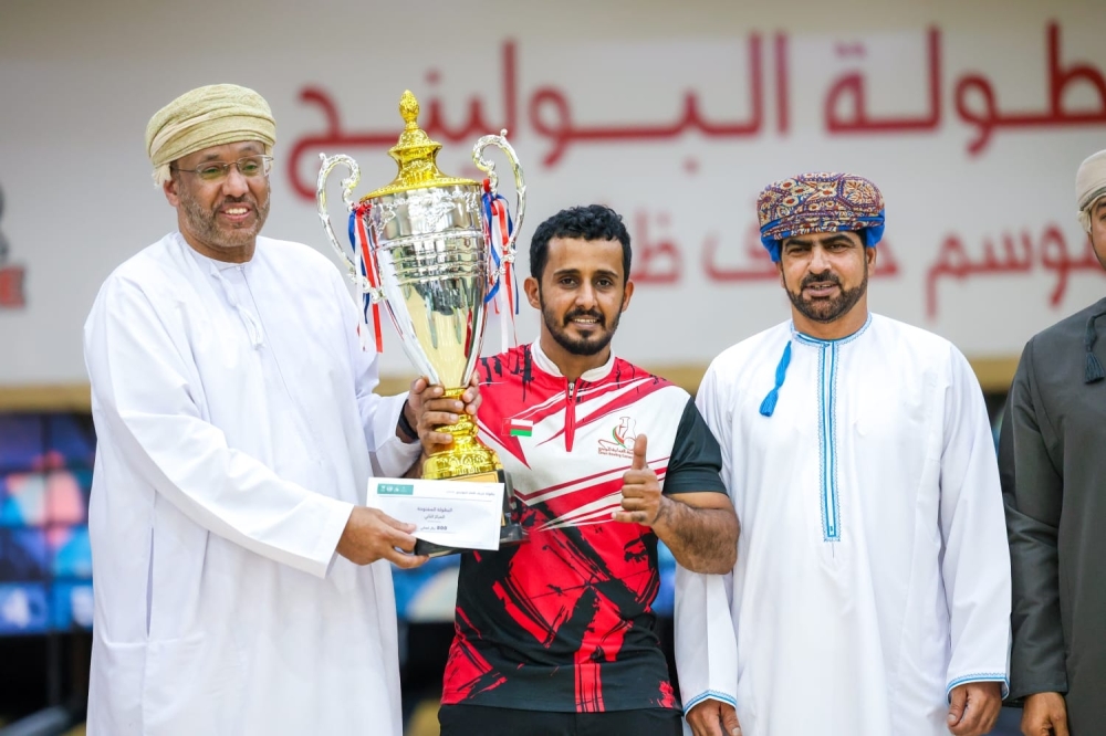 Khalid bin Ahmed Bait Issa receives the Local Championship trophy after claiming the title with 828 points.