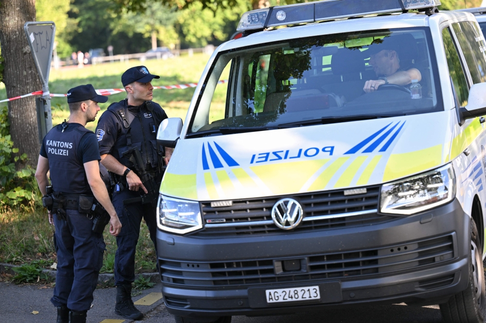 Police officers secure the area where a shooting occurred, in Aarau, northern Switzerland, on 30 August 2026.