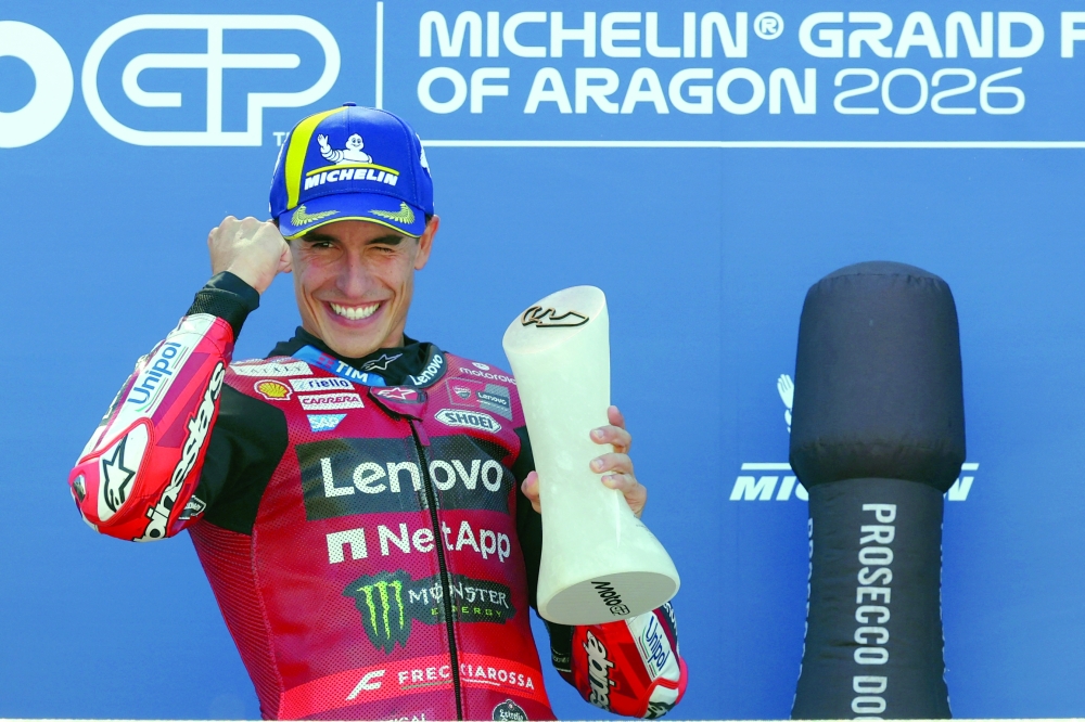 Team Ducati Lenovo Team's Marc Marquez celebrates on the podium after winning the MotoGP race of the Aragon MotoGP Grand Prix at the Motorland circuit in Alcaniz. — AFP