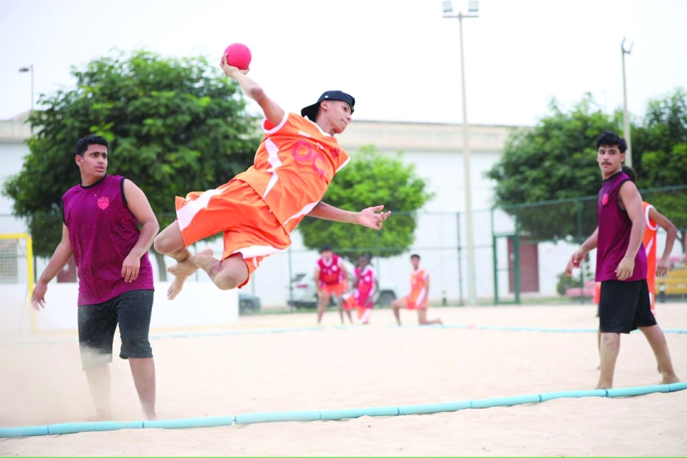 Players compete for possession during the beach handball contests at the Sultan Qaboos Youth Complex for Culture and Entertainment. — Yousef al Siyabi