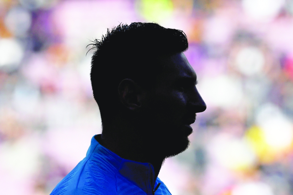 (FILES) Barcelona's Argentinian forward Lionel Messi is silhouetted as he warms up before the Spanish League football match between FC Barcelona and RCD Espanyol at the Camp Nou stadium in Barcelona