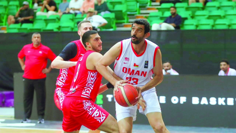 Oman payer battle for possession during their Group A encounter against UAE at the Shabab Al Ahli venue in Dubai. — Ammar al Musafir