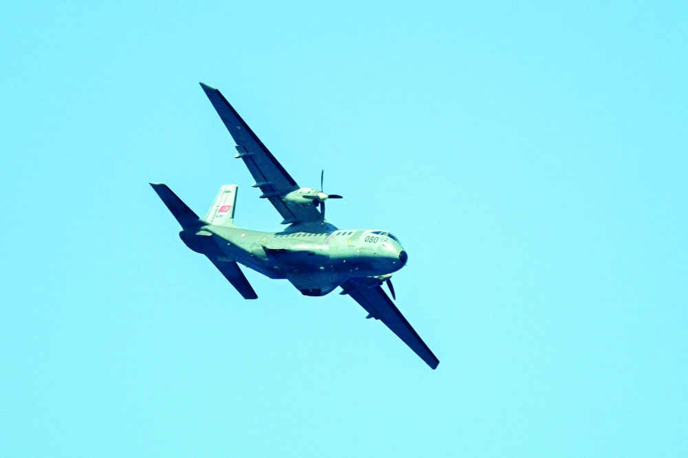 A Turkish aircraft flies over the waters during a rescue operation off the coast of Kyrenia. — AFP