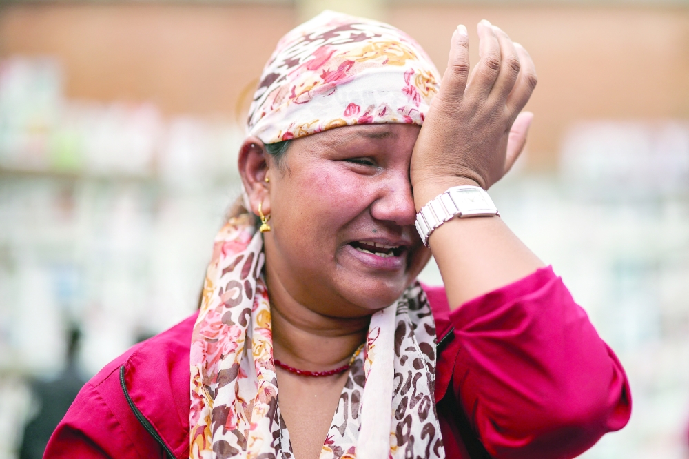 A woman, who has 16 family members still missing following the deadly flash floods and mudslides, reacts outside Tribhuvan University Teaching Hospital, in Kathmandu, Nepal, on Tuesday. — Reuters