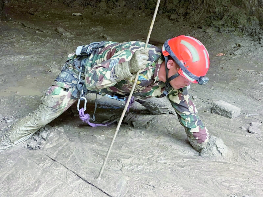 A Nepal Army soldier works during a search and rescue operation in a tunnel near the Hydropower Project sites. — Reuters