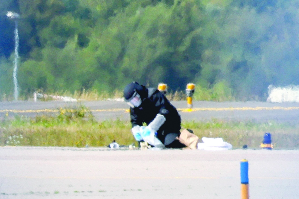 A police officer in protective clothing works at Leipzig/Halle Airport in Schkeuditz, Germany. — Reuters file photo