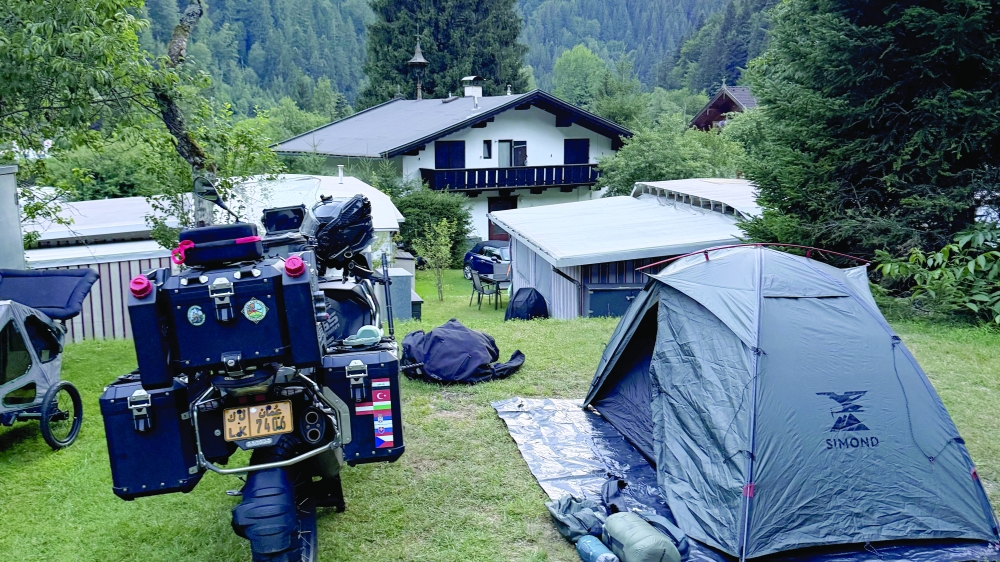 Pitching a tent in Austria with his BMW R 1250 GS Triple Black.