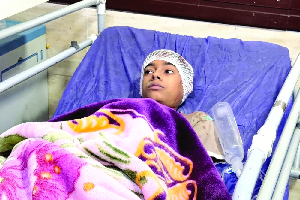 A child lies on a hospital bed receiving treatment following injuries from an overnight strike in Kuhestak, Sirik County, on September 2, 2026.  —  AFP