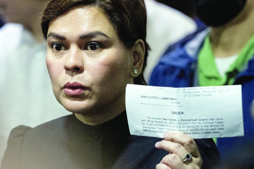 Philippine Vice-President Sara Duterte shows members of the media a court order confirming she posted bail at the Quezon City Regional Trial Court. — Reuters