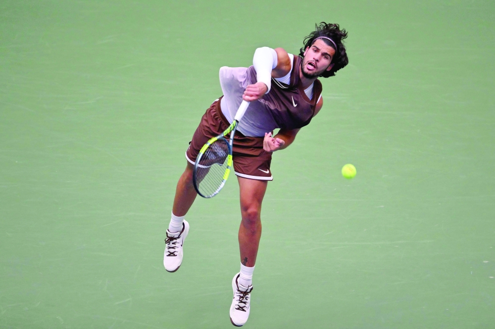 Spain's Carlos Alcaraz serves to China's Wu Yibing during their men's singles third round tennis match on day six of the US Open tennis tournament at the USTA Billie Jean King National Tennis Center in New York City on September 4, 2026. (Photo by ANGELA WEISS / AFP)
