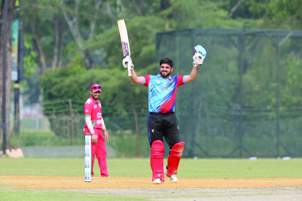 Bilal Tahir celebrates his century against Oman.