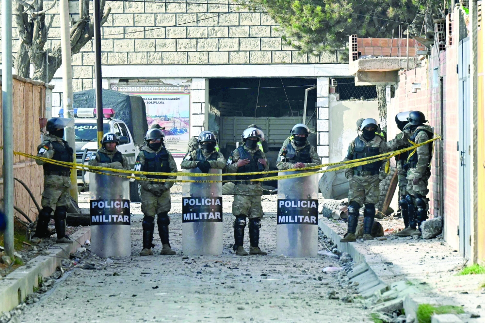 Military police officers stand guard on a street leading to an army barracks in Viacha, Bolivia. — AFP