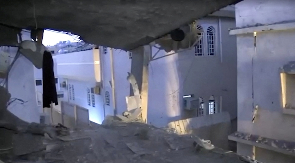 A building stands damaged in the aftermath of strikes, in a location given as Saudi Arabia