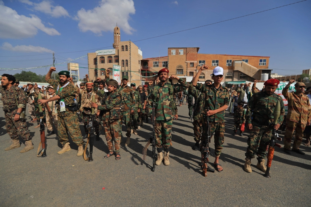 Fighters loyal to the Houthi authorities, shout slogans during a rally to recruit more fighters, in Sanaa on September 10, 2026. 