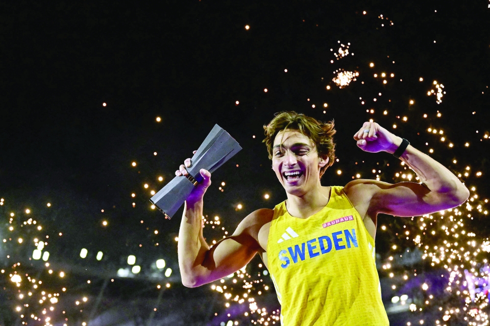 Sweden's Armand Duplantis celebrates with the trophy after his victory in men's pole vault final during the World Athletics Ultimate Championship at the Gyula Zsivotzky National Athletics Centre, in Budapest on September 11, 2026. (Photo by Ben STANSALL / AFP)