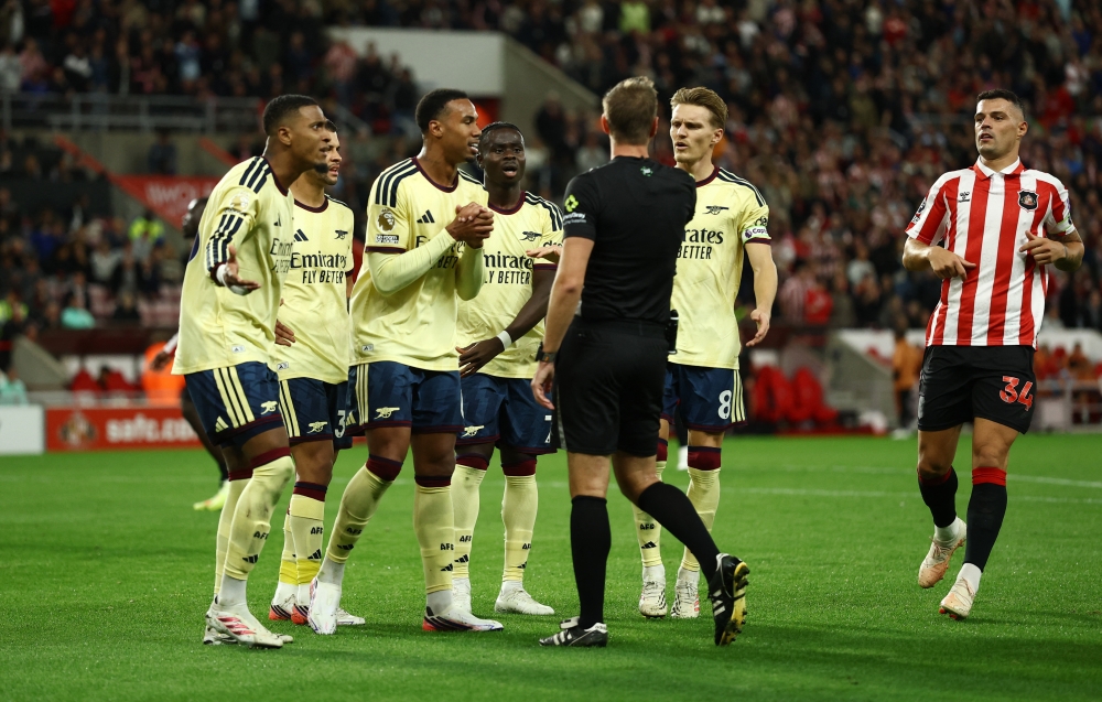  
Arsenal's Ezri Konsa reacts with teammates after referee John Brooks awards a penalty to Sunderland  