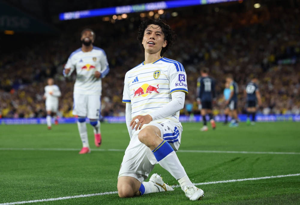  
Leeds United's Ao Tanaka celebrates after their first goal, an own goal scored by Newcastle United's Lewis Miley   