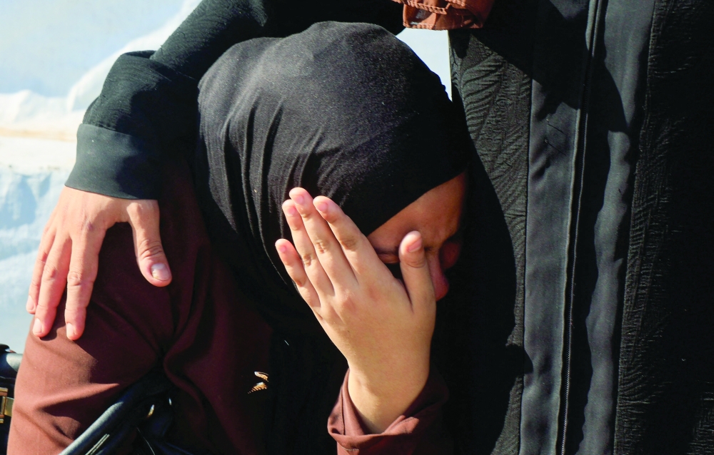 A woman mourns during the funeral of a Palestinian who was killed in an Israeli strike on his tent on Monday, in Khan Younis, in the southern Gaza Strip. — Reuters