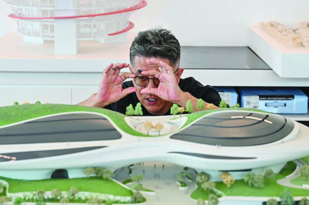 Chinese architect and founder of MAD Architects Ma Yansong speaks next to a model of the Lucas Museum of Narrative Art in Los Angeles that will open on September 22. — AFP