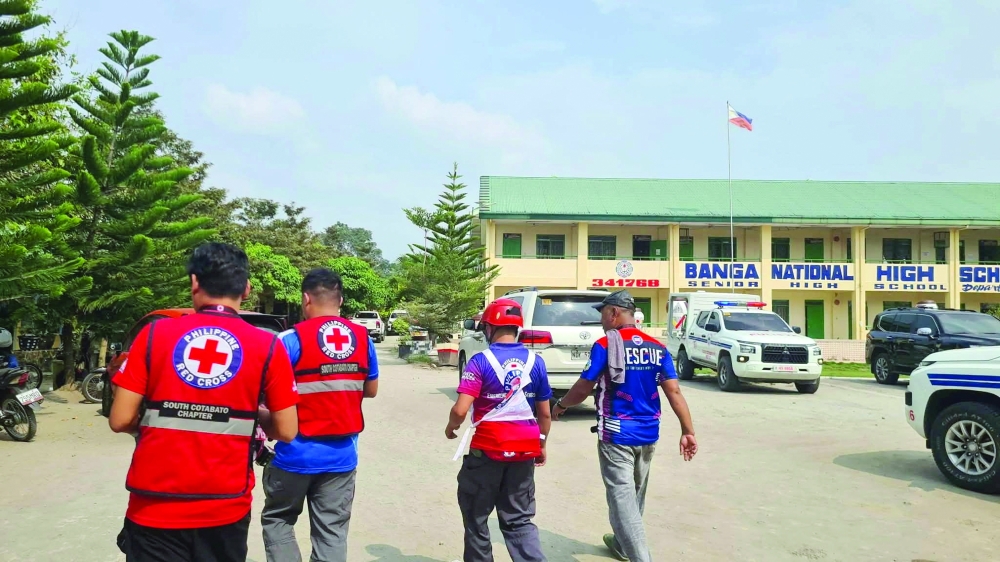 Emergency personnel walk at the site of a deadly shooting at a school in Banga, South Cotabato, Philippines. - Reuters