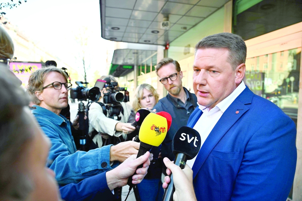 Tobias Baudin, party secretary of Sweden's Social Democrats, talks with journalists outside the party's headquarters in Stockholm. - AFP