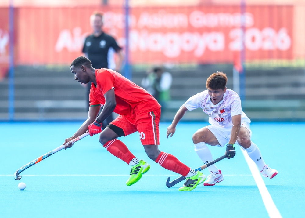Oman and China players fight for the ball.