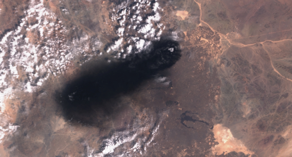 A satellite image shows black smoke rising from an area of Saudi Arabia’s East-West oil pipeline