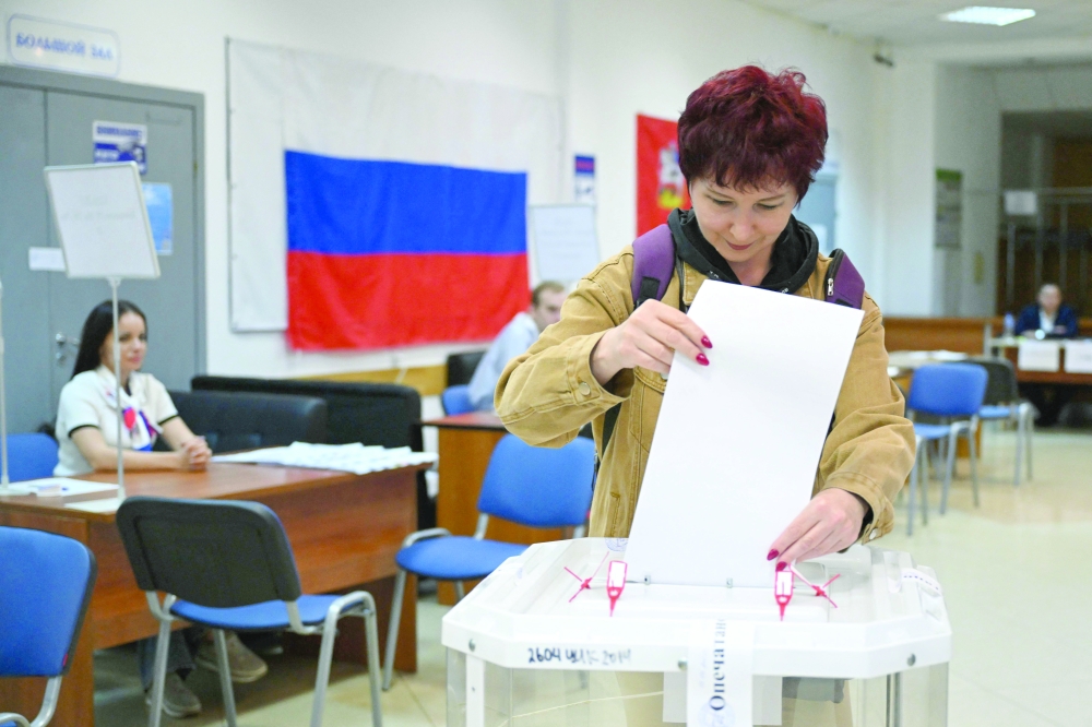A woman casts her ballot for Russia's parliamentary election at a polling station in Klimovsk - the microdistrict of the town of Podolsk in the Moscow region. — AFP