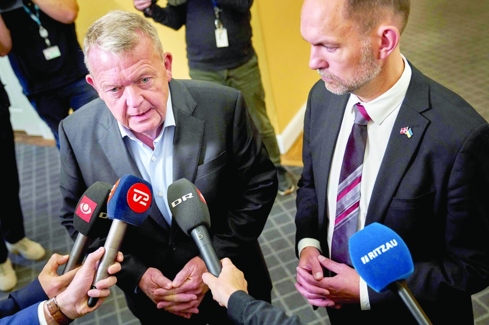 Denmark's Foreign Minister Lars Loekke Rasmussen (L) and Denmark's Defence Minister Jeppe Bruus after a meeting in the Foreign Policy Committee at the Danish Parliament Christiansborg in Copenhagen, Denmark. — AFP