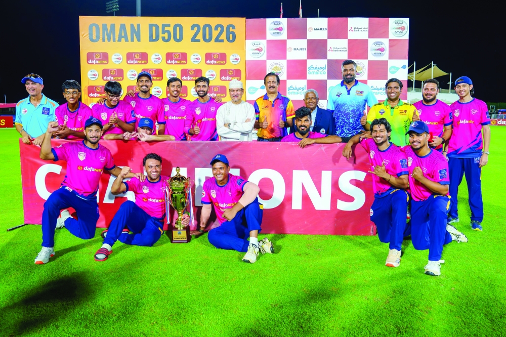 Champions Yalla Shabab Giants players celebrate with the trophy.