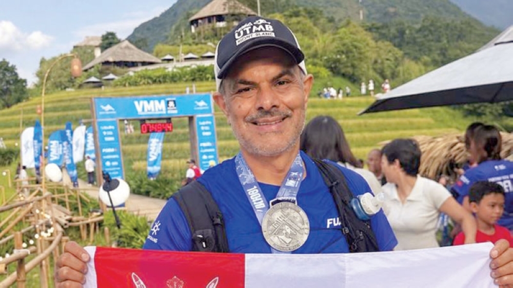Al Nadabi crossed the finish line carrying the Omani flag after negotiating rugged mountain terrain in northern Vietnam.