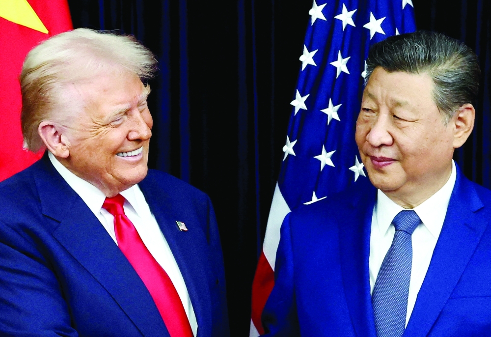 US President Donald Trump and Chinese President Xi Jinping react as they hold a bilateral meeting at Gimhae International Airport, on the sidelines of the Asia-Pacific Economic Cooperation (APEC) summit, South Korea. — Reuters file photo 