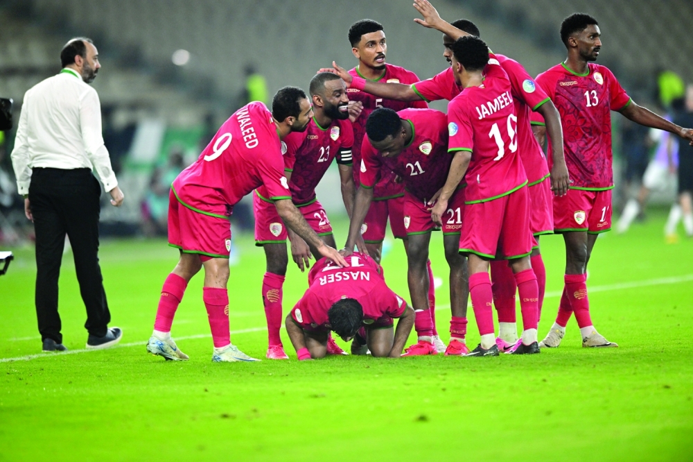 Oman players celebrate the equalising goal by Nasser al Rawahi. — Abdulwahid al Hamadani