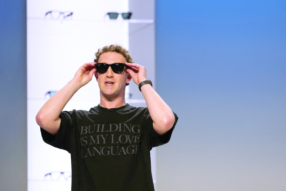 Meta CEO Mark Zuckerberg tries on Meta smart glasses.