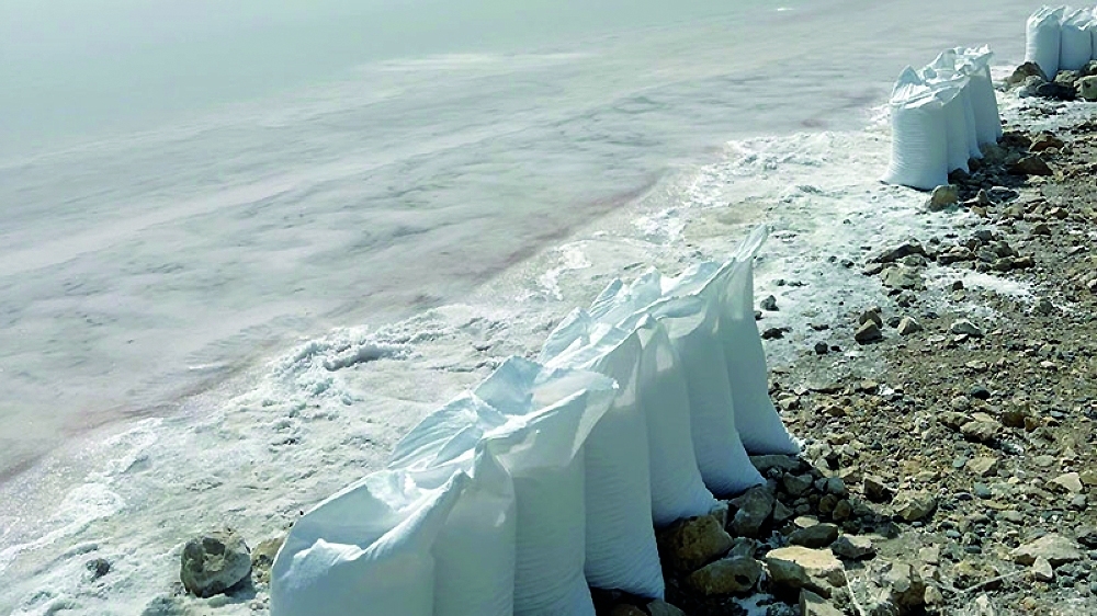 White sacks line the edge of Shannah salt flats.