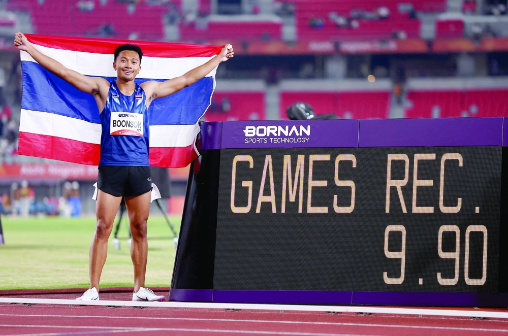Asian Games - Aichi-Nagoya 2026 - Athletics - Paloma Mizuho Sports Park, Nagoya, Japan - September 25, 2026
Gold medallist Thailand's Puripol Boonson celebrates after winning the Men's 100m Final with a games record REUTERS/Chalinee Thirasupa