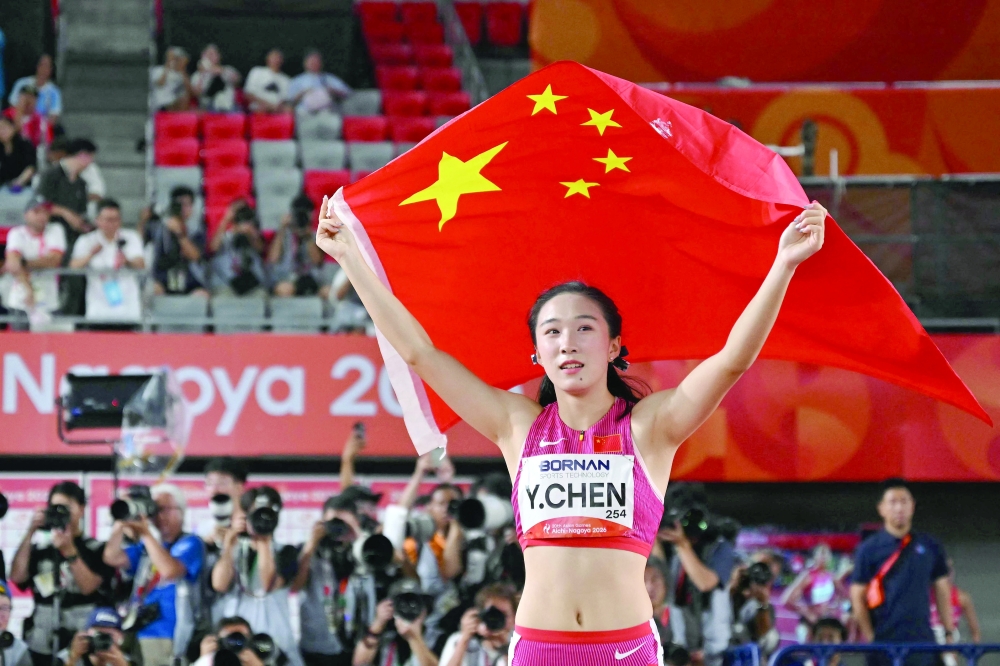 China's Chen Yujie celebrates after winning the women's 100m final during the 2026 Asian Games at Nagoya City Mizuho Park Athletic Stadium in Nagoya, Aichi Prefecture on September 25, 2026. (Photo by MOHD RASFAN / AFP)
