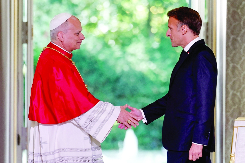France's President Emmanuel Macron and Pope Leo XIV during a ceremony following their meeting at the Elysee Presidential Palace in Paris. - AFP