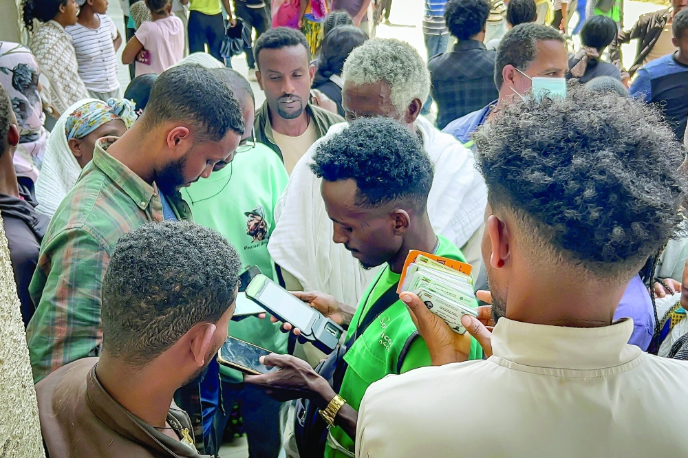 Residents gather to purchase and activate SIM cards at a telecommunications retailer in Mekelle amid telecommunications and Internet disruptions. - AFP