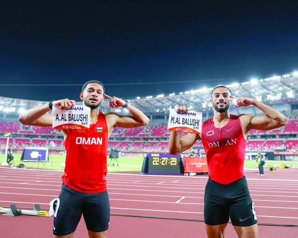 Oman's silver medallist Ali al Balushi and bronze medallist Mulham al Balushi celebrate after the men's 100m final at the Asian Games - Aichi-Nagoya 2026 in Nagoya, Japan.