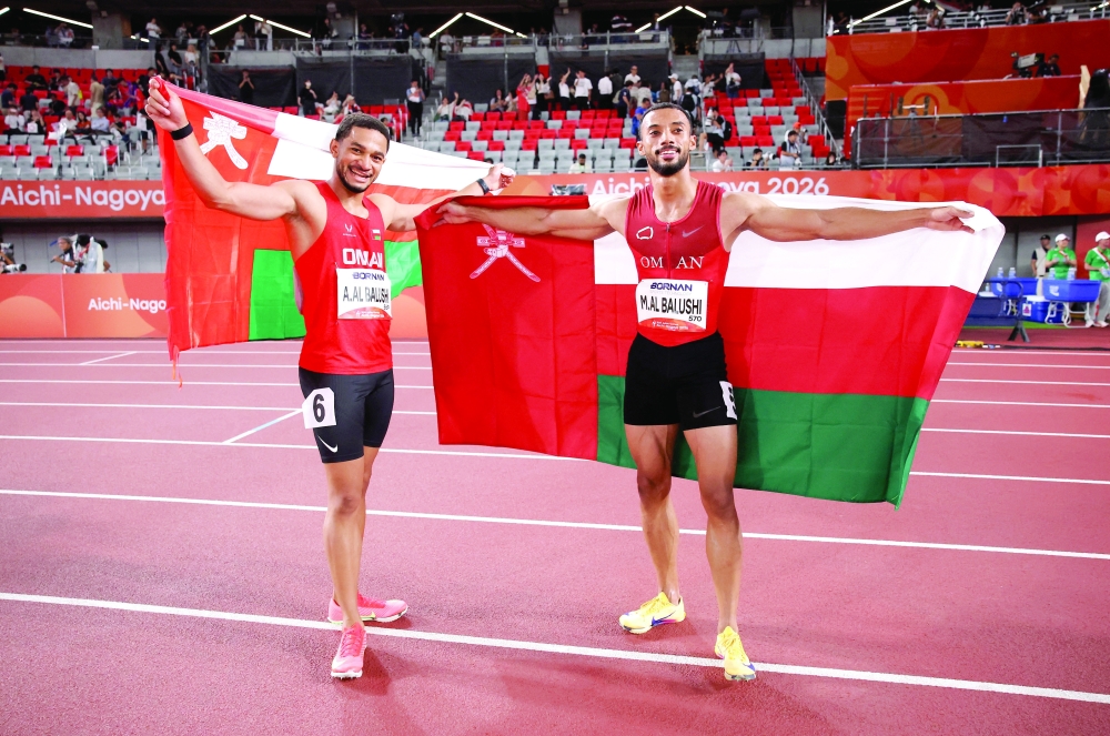 Oman's silver medallist Ali al Balushi and bronze medallist Mulham al Balushi celebrate after the men's 100m final at the Asian Games - Aichi-Nagoya 2026 in Nagoya, Japan. — Reuters